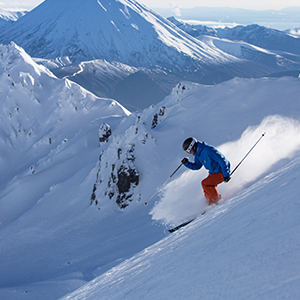 A person skiing down a vast mountain