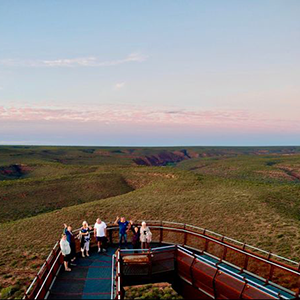 People walking along Kalbarri Skywalk at sunset