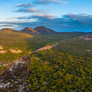 Ariel image of rolling green mountain ranges and blue ski in Cape Le Grand National Park