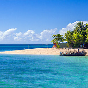 View of a boat in the shallow, crystal-clear turquoise waters of Green Island