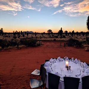 Outdoor dining setup in serene desert twilight