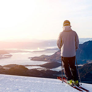 A skier looking out over Lake Wanaka from Treble Cone