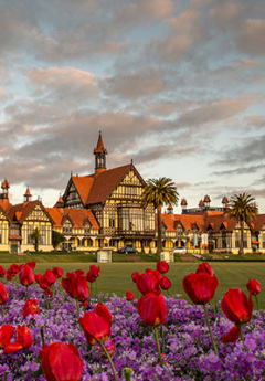 View of Rotorua Museum and colorful flowers in the front